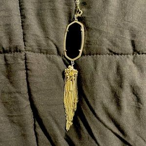 It is is very good condition and is black with a silver chain
